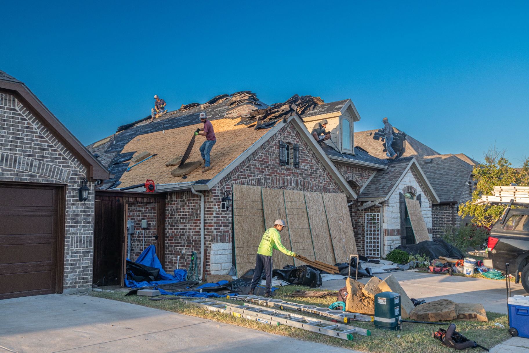Roofing crew replacing shingles on a Dallas–Fort Worth home